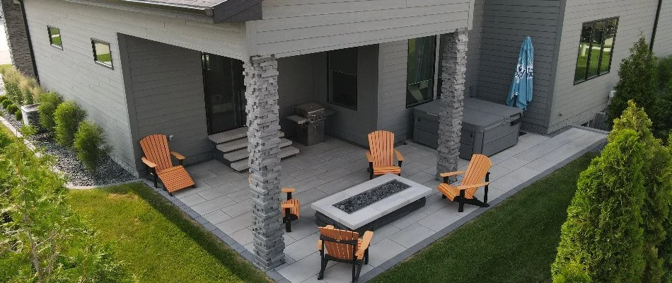 Fire pit on a patio in Waukee, IA, surrounded by chairs.